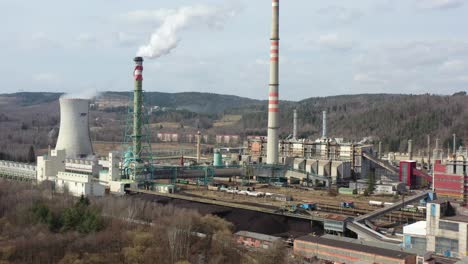 Aerial-view-of-Sokolovska-Uhelna,-a-coal-fired-power-plant-in-landscape-of-Czech-Republic,-smoke-and-steam-goes-into-atmosphere,-drone-shot