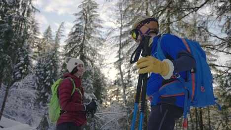 Happy-couple-talking-and-laughing-together-in-alpine-snow-forest