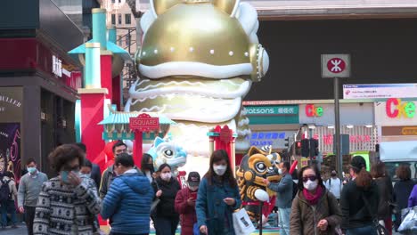 Pedestrians-walking-past-a-Lunar-Chinese-New-Year-street-art-theme-decorative-display-figures-as-citizens-get-ready-for-the-festivities-in-Hong-Kong