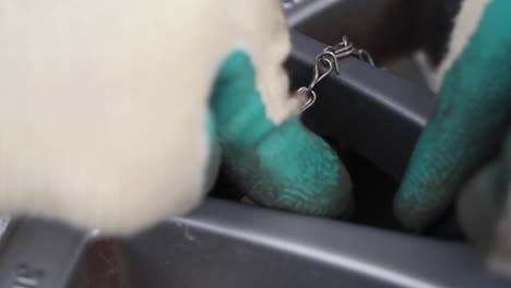 Macro-shot-hands-with-gloves-pressing-a-air-gauge-on-a-valve-of-summer-tire