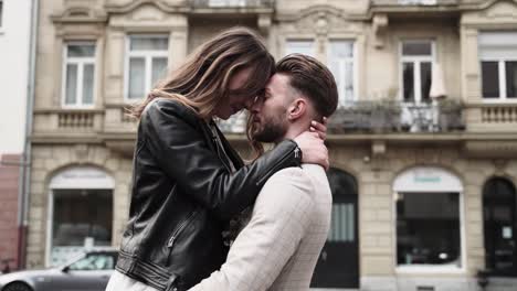 Retro-Styled-urban-wedding-couple-having-intesive-dreamfull-moment-in-the-city-streets-with-a-lot-of-feeling-while-groom-holding-her-bride-up-with-his-hands