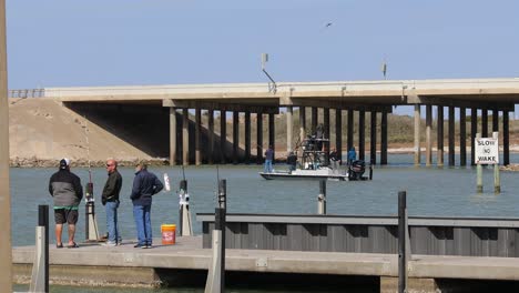 Three-men-standing-on-the-dock-on-Packery-Channel