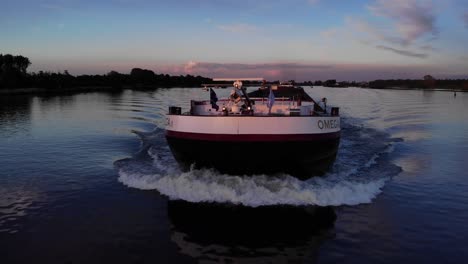 Splashing-Waves-From-A-Large-Traveling-Barge-Ship-At-Dusk