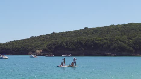 People-Paddling-on-SUPs-in-Galapinhos-Beach,-Portugal