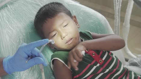 Young-dentist-is-working-on-a-children-in-his-office