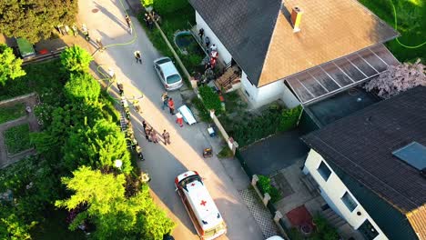 AERIAL---Paramedics-leaving-the-scene-of-a-fire-in-Oberwaltersdorf,-Austria