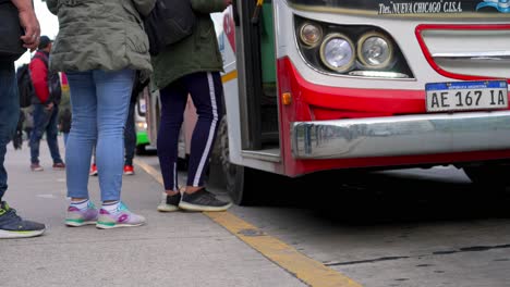 Low-angle-shot-of-public-entering-bus-in-Buenos-Aires,Slow-motion-shot