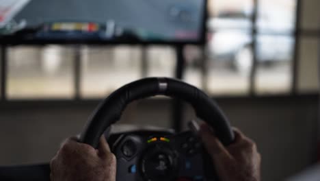 simulator-car-racing-game-with-man-playing-with-steering-wheel