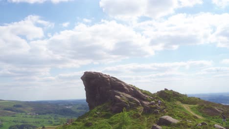 Handheld-static-shot-of-two-men-walking-along-Ramshaw-Rocks-,-Leek,-Staffordshire,-England