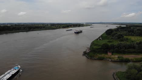 High-Angle-Aerial-View-Of-Ships-Navigating-Oude-Maas-Past-Coastal-Radar-Tracking-Tower