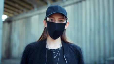 Girl-in-protective-mask-looking-at-camera-on-street.-Woman-wearing-mask