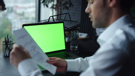 Businessman-reading-report-on-document-in-office.-Freelancer-having-video-chat