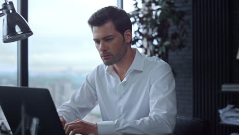 Businessman-using-laptop-computer-in-office.Employee-typing-on-computer-keyboard