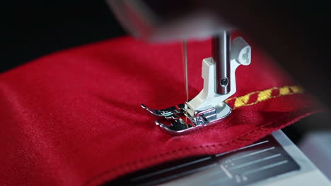 Sewing-needle-stitching-seam-on-fabric-in-slow-motion-.-Sewing-machine-in-action
