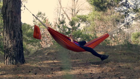 Young-woman-in-hammock-in-forest.-Outdoor-recreation.-Spring-leisure