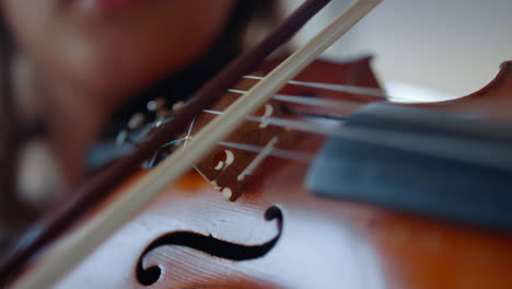 Closeup-young-woman-hand-playing-violin.-Teenage-girl-using-violin-bow