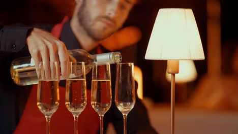 Focused-guy-preparing-alcohol-for-people-in-restaurant.-Man-pouring-champagne
