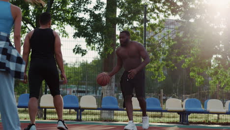 Multi-ethnic-sporty-friends-training-street-basketball-in-sport-playground.