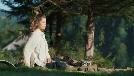 Attractive-girl-enjoying-yoga-in-mountains.-Yoga-woman-sitting-on-grass.
