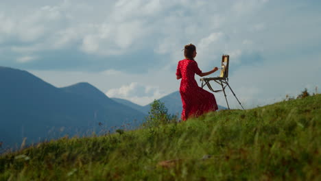 Unknown-woman-artist-drawing-outdoors.-Lady-painter-painting-in-mountains.