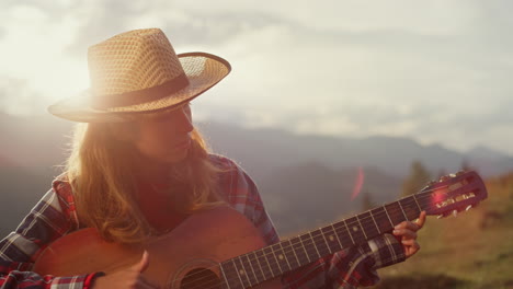 Closeup-musical-woman-play-guitar-instrument-in-mountains.-Girl-compose-music.