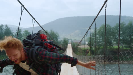Euphoric-hiker-jump-outdoors-on-river-bridge.-Backpacker-feel-happiness-close-up