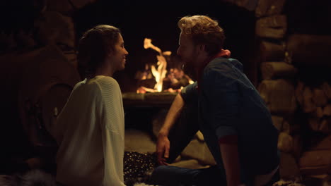 Cozy-lovers-rest-fireplace-in-country-house.-Lovely-couple-flirting-at-date.