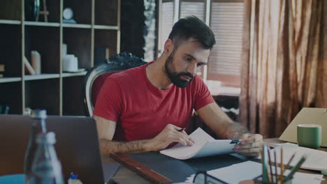 Businessman-reading-documents-in-office.-Beard-man-working-with-paper-documents