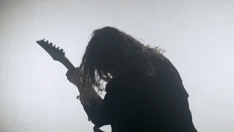 Rock-musician-silhouette-playing-electric-guitar.-Expressive-rock-guitarist