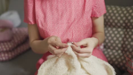 Knitting-woman-hand-making-wool-clothes.-Woman-hobby-knitting-woolen-fabric