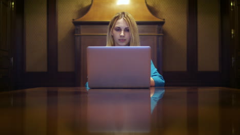 Business-woman-working-on-laptop-computer-sitting-at-desk-in-home