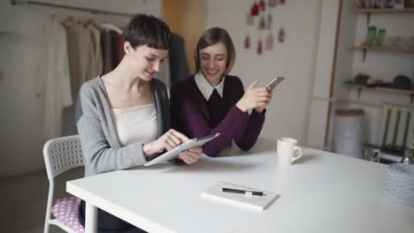 Two-young-woman-have-fun-leisure-and-using-electronic-devices-for-communication