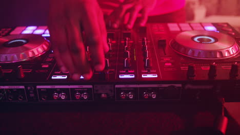 DJ-control-music-console.-DJ-hands-mixing-music.-Musical-player-and-turntable