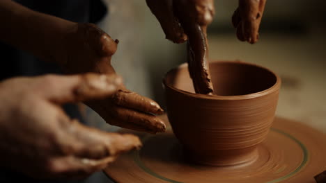 Woman-using-potters-wheel-in-pottery.-Masters-making-handmade-product