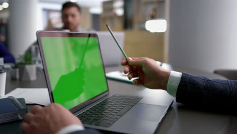 Businessman-using-laptop-greenscreen-analyze-corporate-data-on-conference-table.