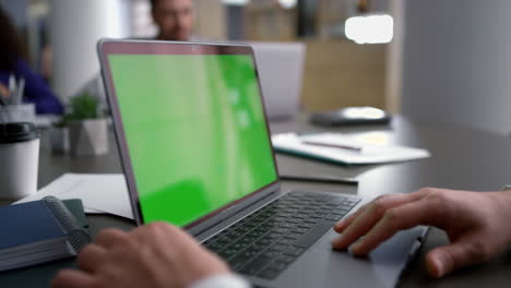 Entrepreneur-man-searching-laptop-green-screen-on-diverse-business-team-meeting.