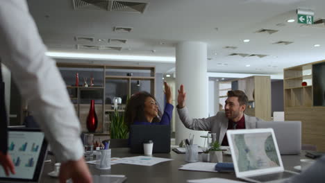 Happy-office-team-celebrating-business-deal.-Diverse-corporate-group-high-five.
