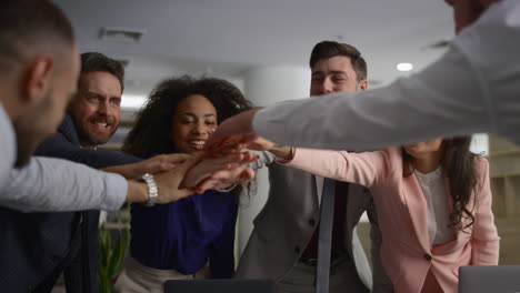 Diverse-employees-celebrate-success.-Business-team-high-five-on-office-meeting.