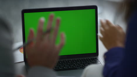 Multiracial-coworkers-team-calling-video-chat-using-laptop-green-screen-at-desk.