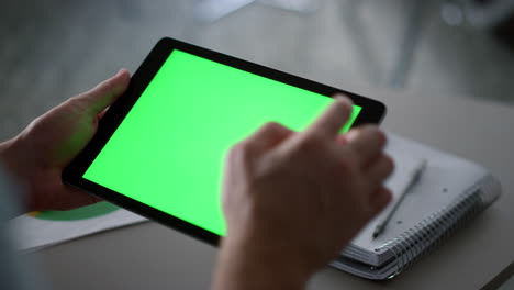 Businessman-swiping-tablet-pad-green-screen-analyzing-corporate-data-in-office.