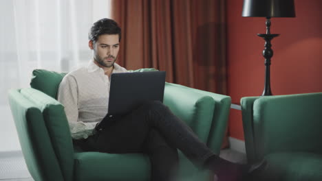 Handsome-businessman-working-laptop-at-hotel.-Business-man-working-computer
