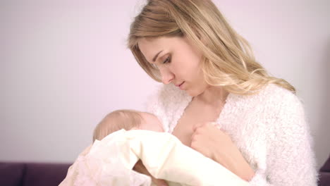 Mother-holding-baby-on-hands.-Cheerful-mother-breastfeeding-baby