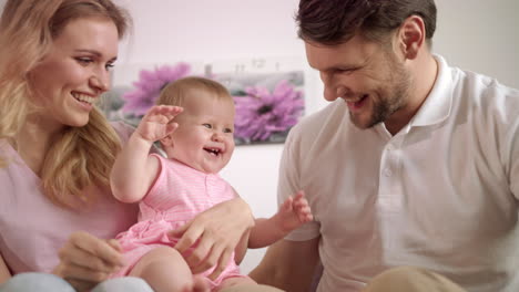 Happy-parents-playing-with-baby.-Portrait-of-sweet-family-together
