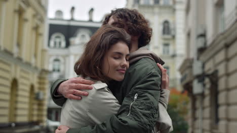 Lovely-couple-hugging-on-street.-Happy-girlfriend-leaning-to-boyfriend-outdoor.