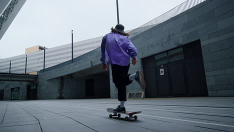 Skater-guy-riding-in-street.-Skateboarder-training-outdoors-in-morning.