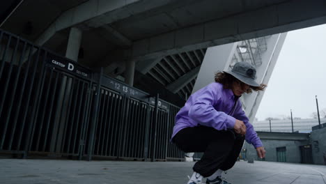 Active-skater-practicing-kickflip-outdoor.-Hipster-jumping-on-skate-in-stadium.