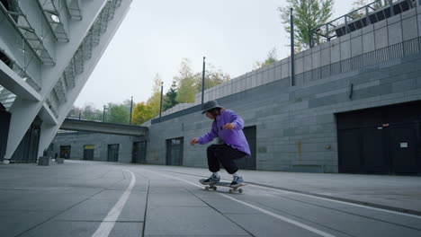 Cool-skater-making-trick-on-skateboard-outside.-Sporty-man-jumping-on-longboard.