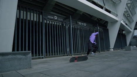 Sporty-man-practicing-skateboarding-outside.-Skater-falling-in-city-stadium.
