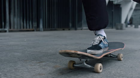 Unknown-skater-riding-on-board-outdoor.-Unrecognizable-man-feet-skating-outside.
