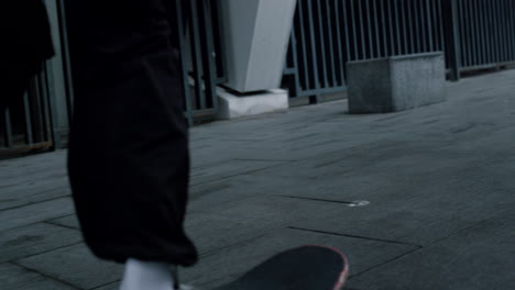 Unknown-person-jumping-on-skate-outside.-Skater-running-with-longboard-outdoor.